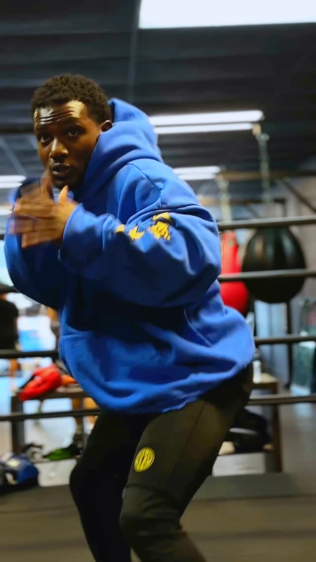 Kenneth Sene shadowboxing in a blue hoodie
