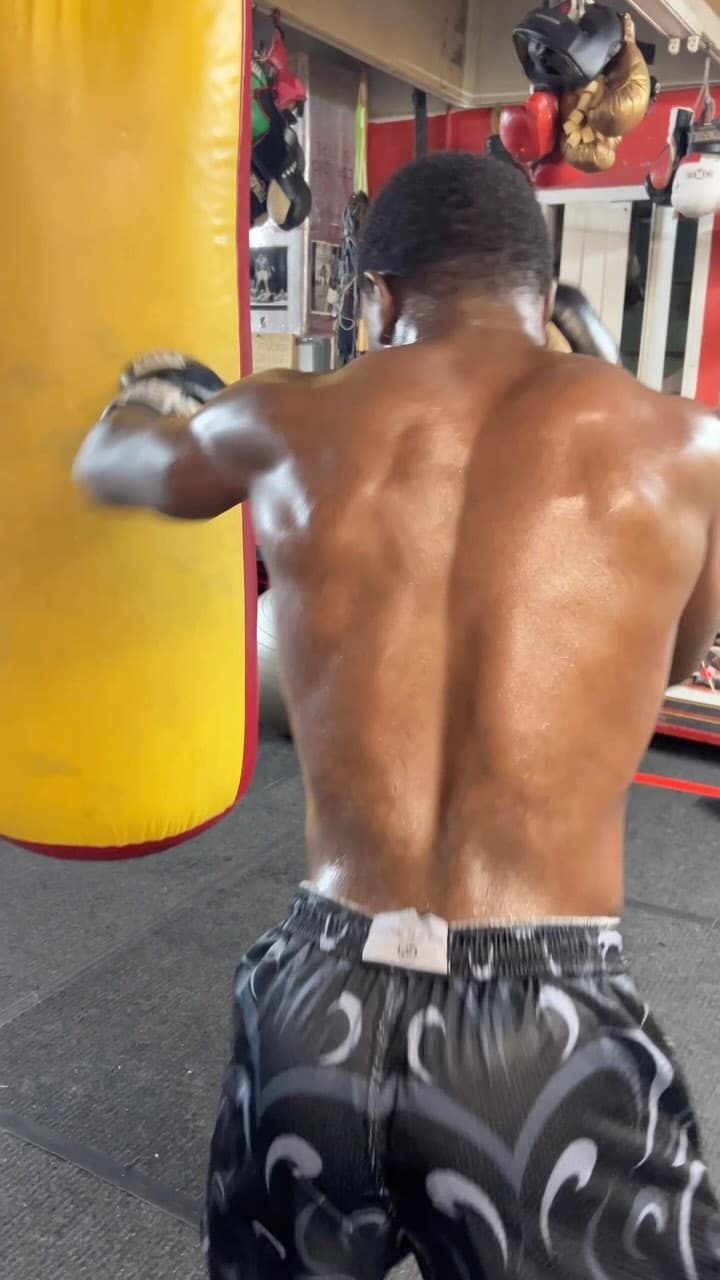 Kenneth Sene from behind, working the heavy bag